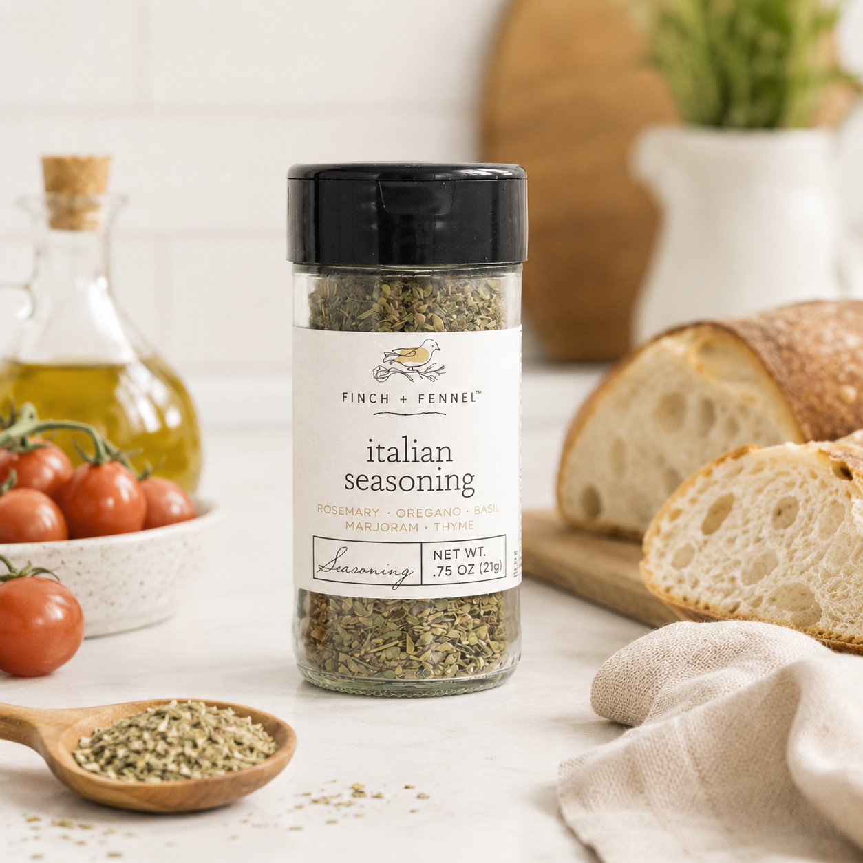 Jar of Italian seasoning with bread and tomatoes on a table