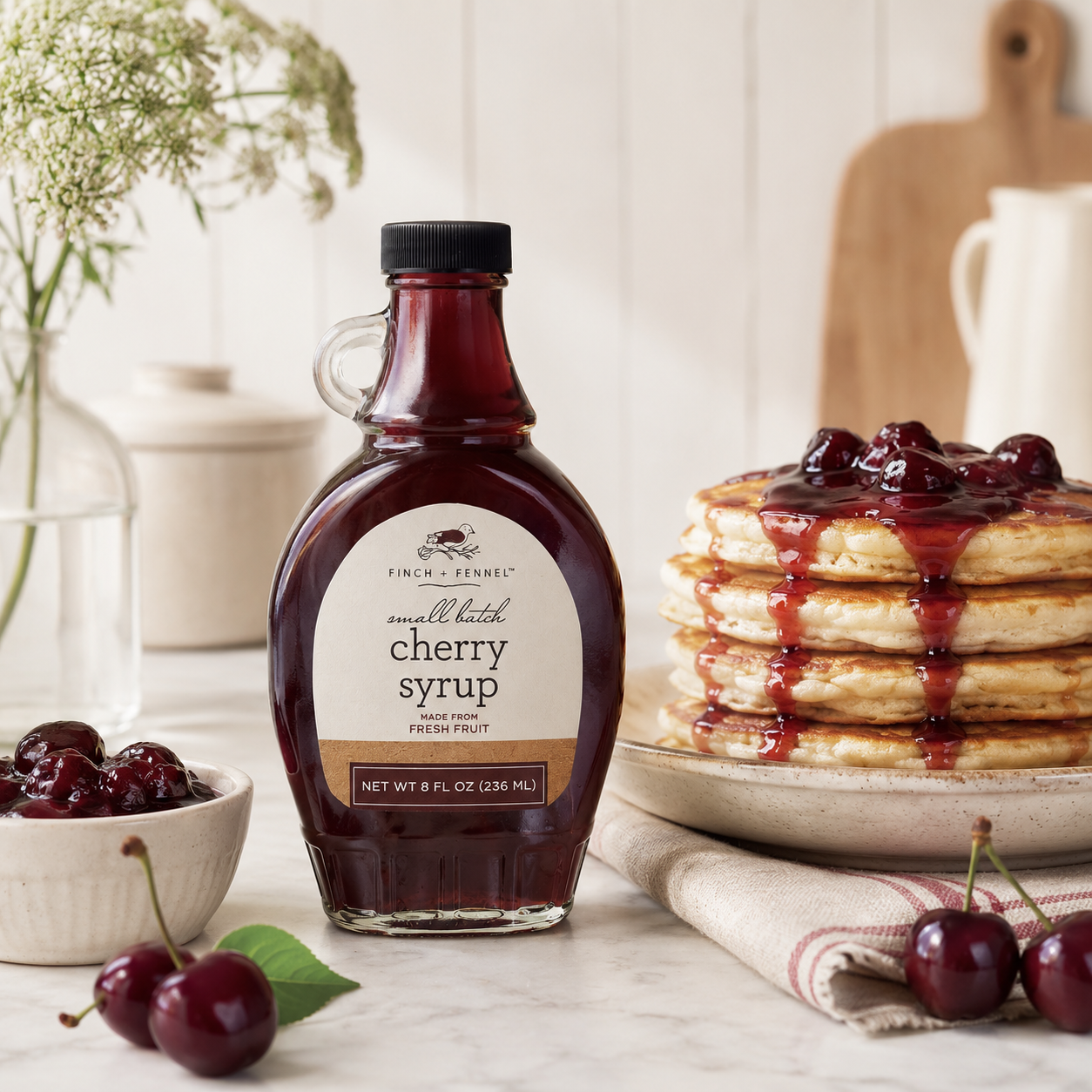 Finch and Fennel small batch cherry syrup made with Michigan cherries, styled with pancakes and cherries.